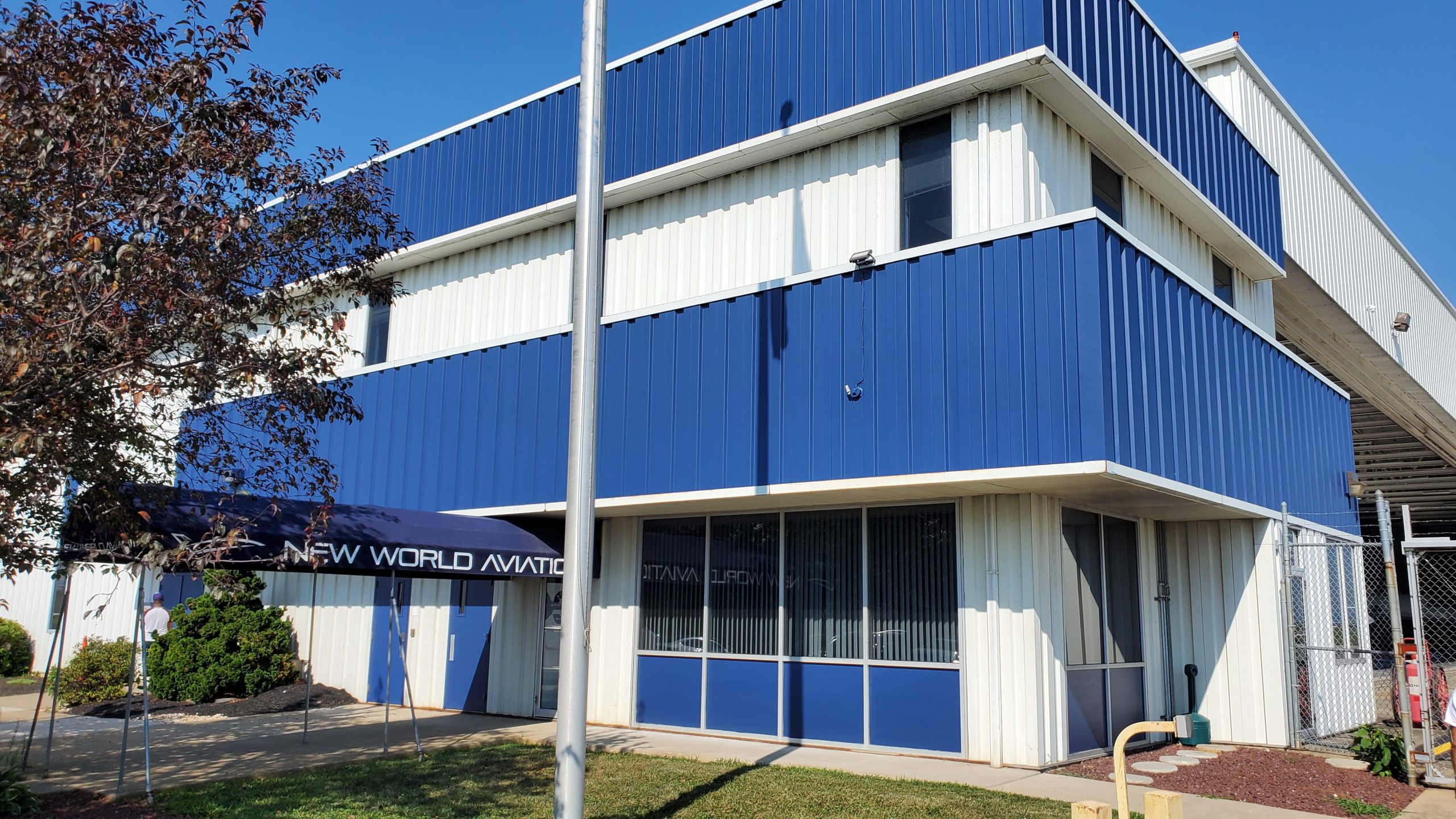 Front corner angle of completed commercial exterior painting project at New World Aviation in Allentown, PA, by CertaPro Painters of the Greater Lehigh Valley - Angle 2