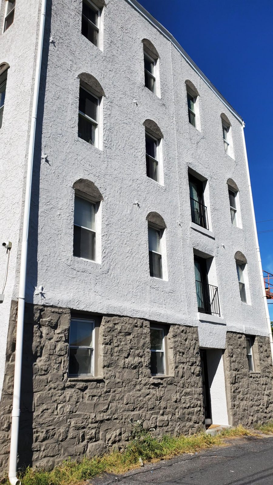 Side of River Rock Management after completed commercial exterior painting project by CertaPro Painters of the Greater Lehigh Valley - Angle 2 Preview Image 2