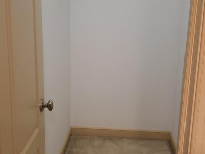 Closet with white walls and tan doors in Easton, PA, after completed residential interior painting project by CertaPro Painters of the Greater Lehigh Valley
