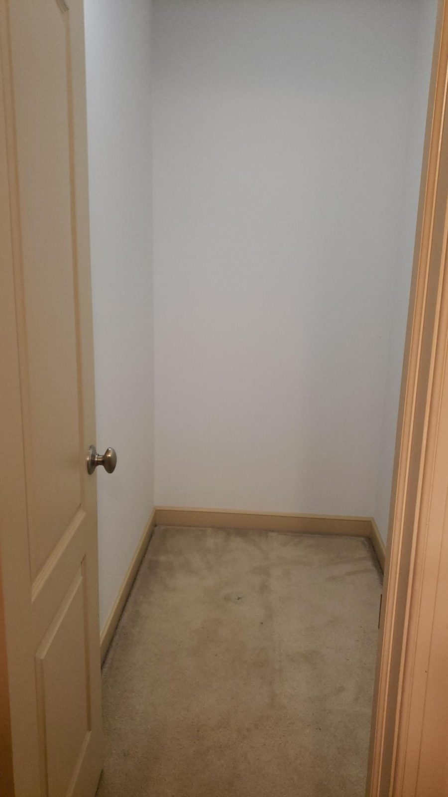 Closet with white walls and tan doors in Easton, PA, after completed residential interior painting project by CertaPro Painters of the Greater Lehigh Valley