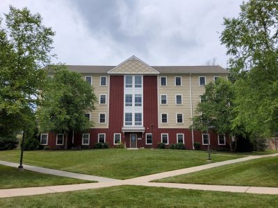 student dorm housing exterior painting tan and maroon