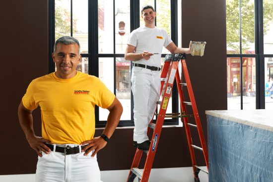 CertaPro Team Members Posing For the Camera While Painting an Interior