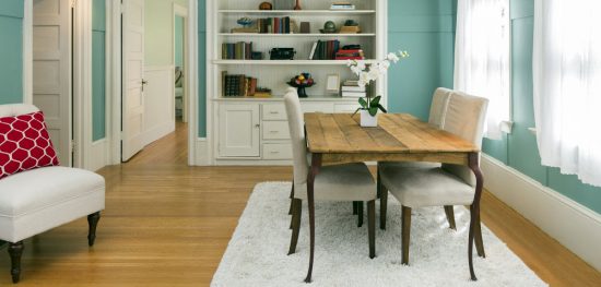 dining room with light blue walls and hadwoos floors