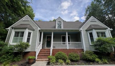 front side of house with repainted pale green siding