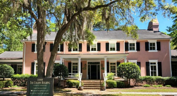 After photo of building 100 with black repainted shutters and front door painted shutters and windows