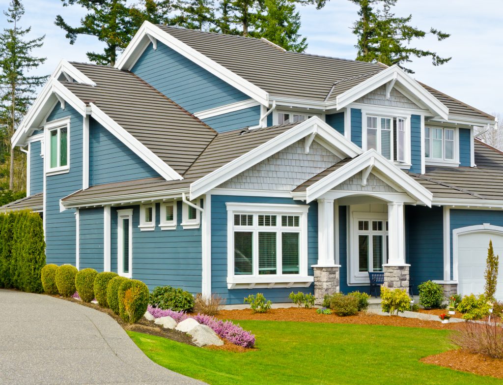 Exterior painted blue siding and white trim. - CertaPro Painters