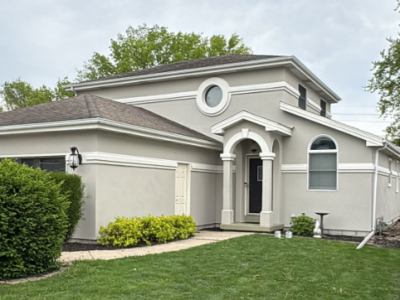 painted stucco house with white trim accents