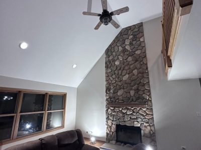 living room with stone fireplace