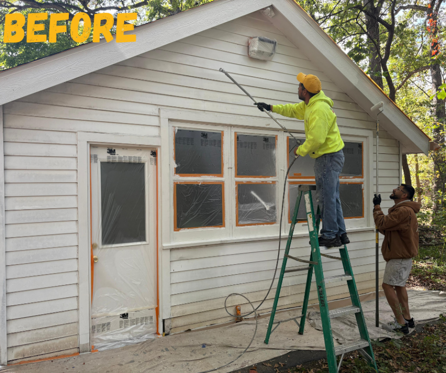 painter on ladder spraying exterior siding Preview Image 1