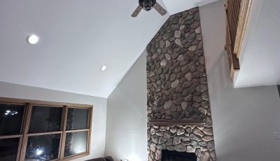 living room with stone fireplace