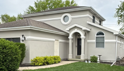 painted stucco house with white trim accents