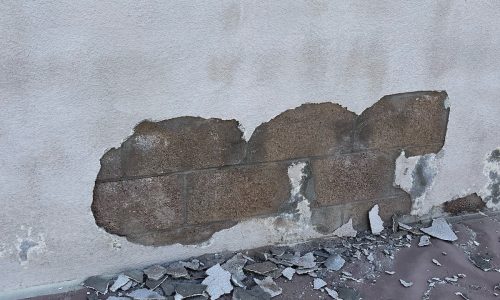 Another area showing stucco damage.