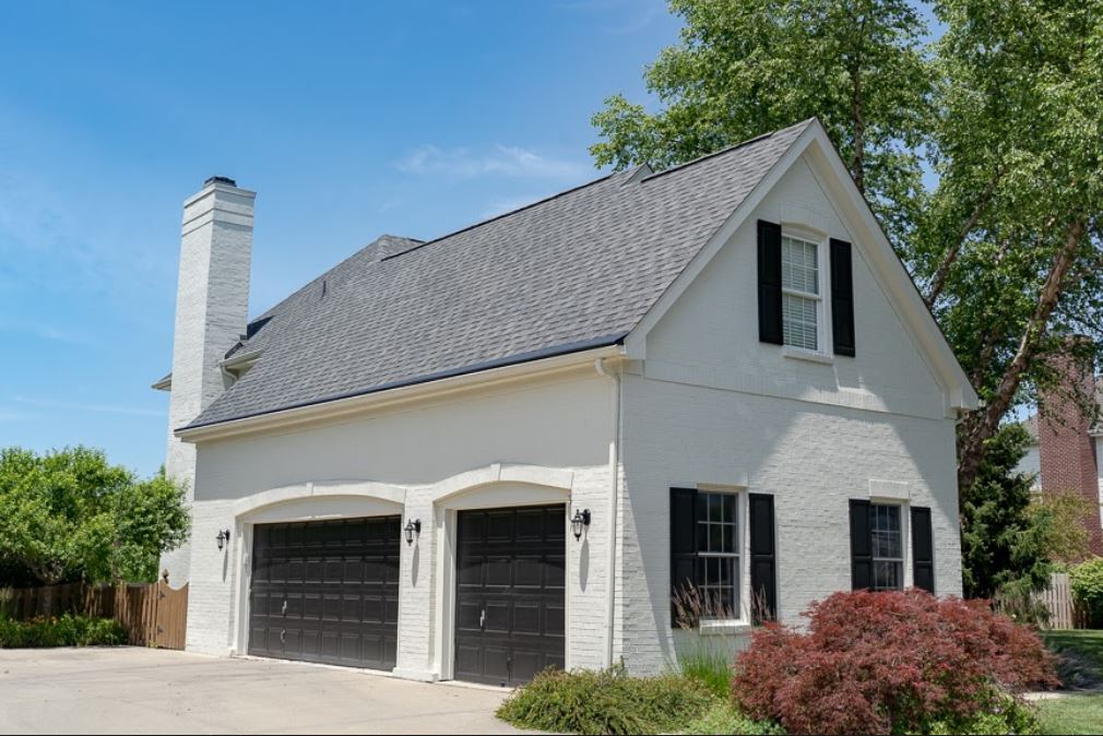 white painted home with black garage doors
