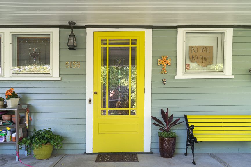 yellow painted door on home with light green siding Preview Image 1