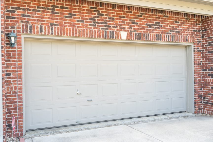 white painted garage door on brick home Preview Image 1