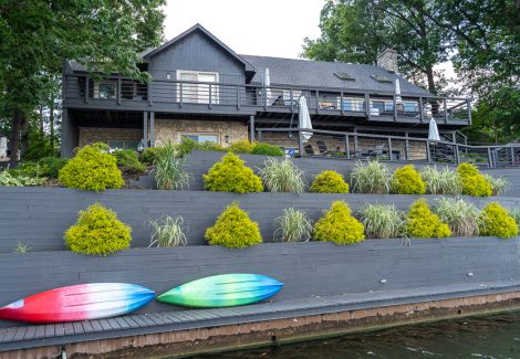 view from water front of decking and home after painting project