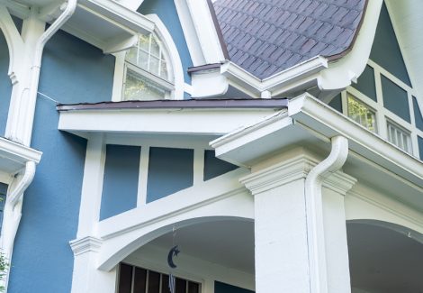 white posts and gutters on blue home
