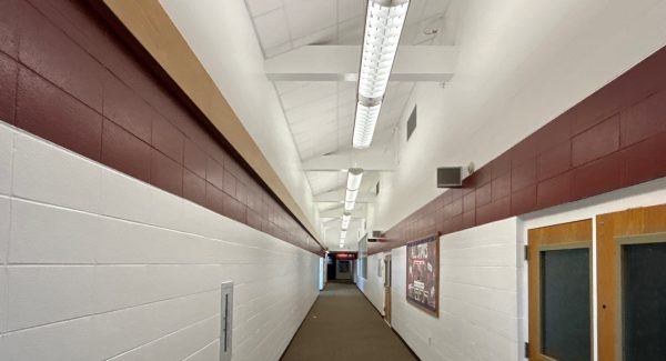 repainted white school hallway with red stripe