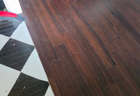 wooden flooring meeting with black and white checkered flooring