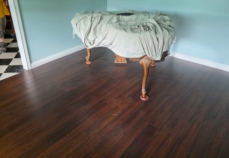 wooden flooring in room with covered end table