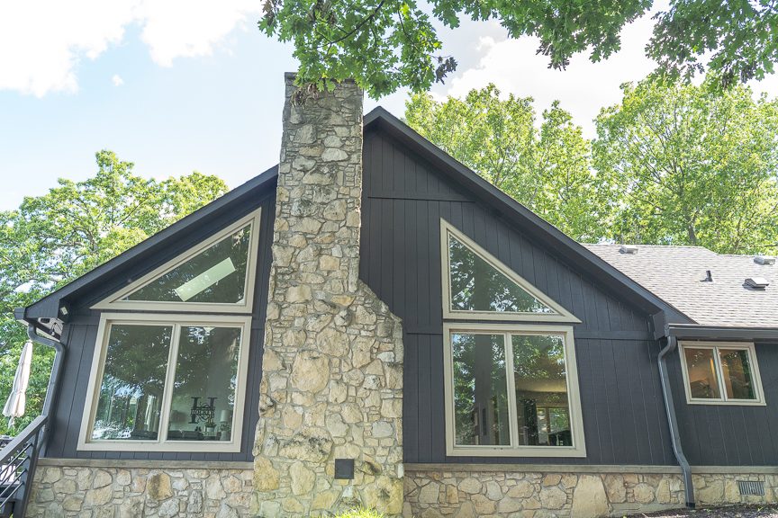 side of home with painted wood siding and masonry chimney Preview Image 11