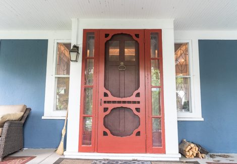 salmon front door on blue house