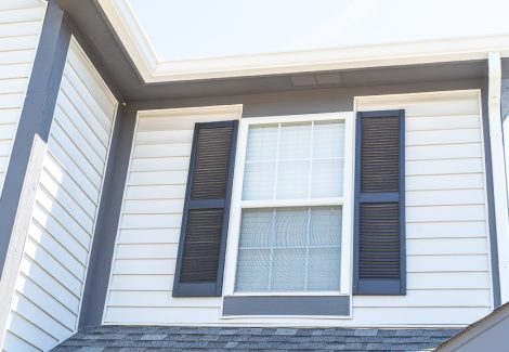 white siding with dark gray shutters close up