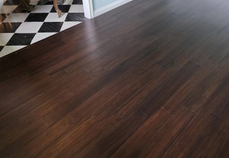 wooden flooring meeting with black and white checkered flooring