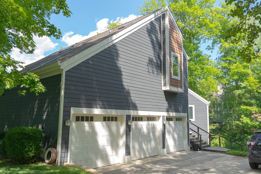 side of home with garage doors after painting Preview Image 1