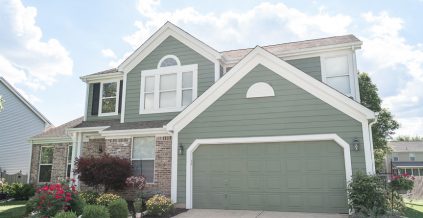 Green House with White Trim