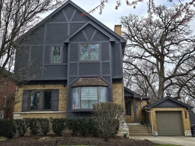 Dark grey exterior siding painting in Western Springs.