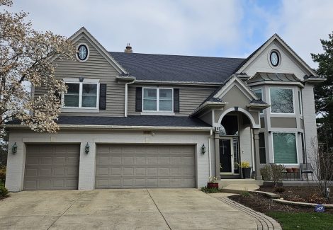 Tan exterior painting with refreshed shudders and garage door protective coat in Indian Head Park.