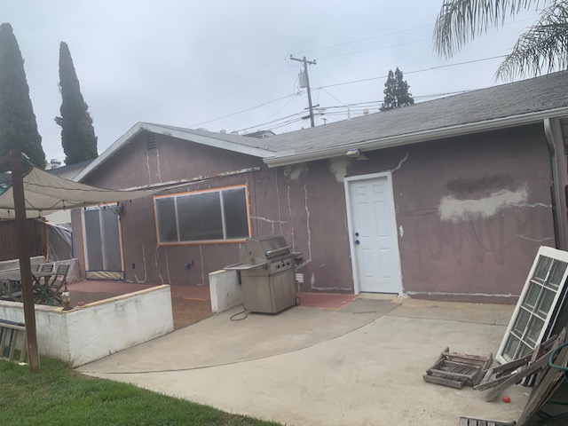 A stucco ranch style house in San Diego gets prepped for repainting on its exterior.