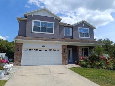 Exterior painting in Auburndale, FL in dark grey paint.