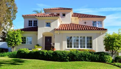 Home painted beige with a red roof