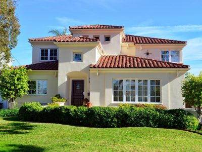 Home painted beige with a red roof