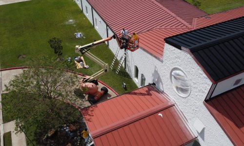 Using the boom lift to paint up high