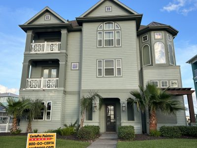 painted house exterior with light green siding and darker green trim