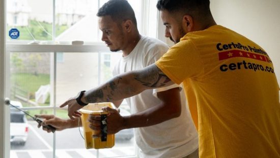 CertaPro Painters Painting Windowsill with roller