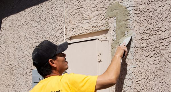 certapro crew member repairing stucco exterior