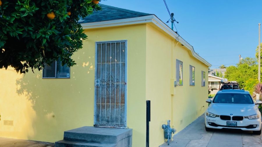 stucco house painted bright yellow. Preview Image 1