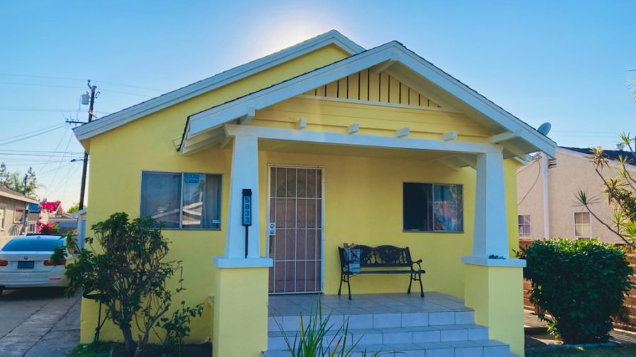yellow house with light blue trim. Preview Image 2