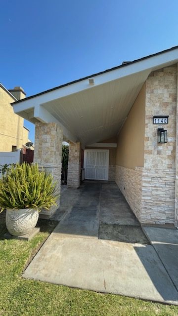 Stone and stucco home repainted in a medium tan. Preview Image 1
