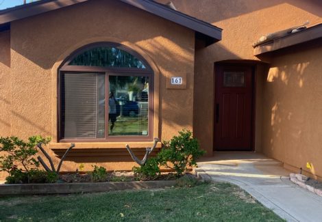 Front of stucco house showing the dark umber color choice.