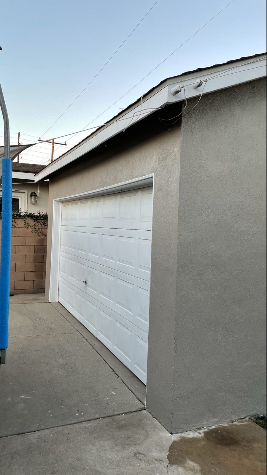 gray stucco garage with white doors. Preview Image 3