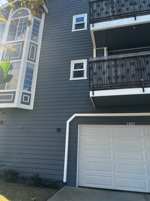 black railings on repainted condominium with white trim. Preview Image 1
