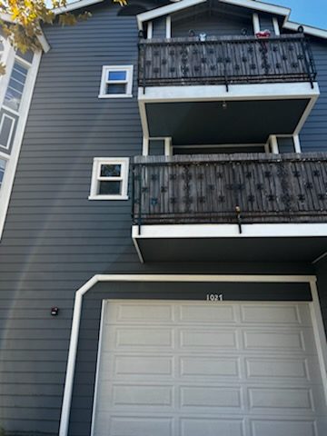 Condo complex painted a dark gray with white trim. Preview Image 3