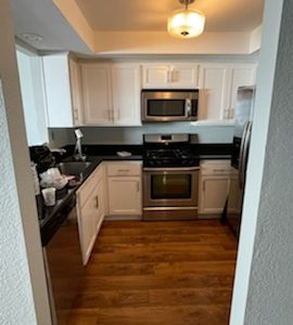Kitchen cabinets after being repainted white.