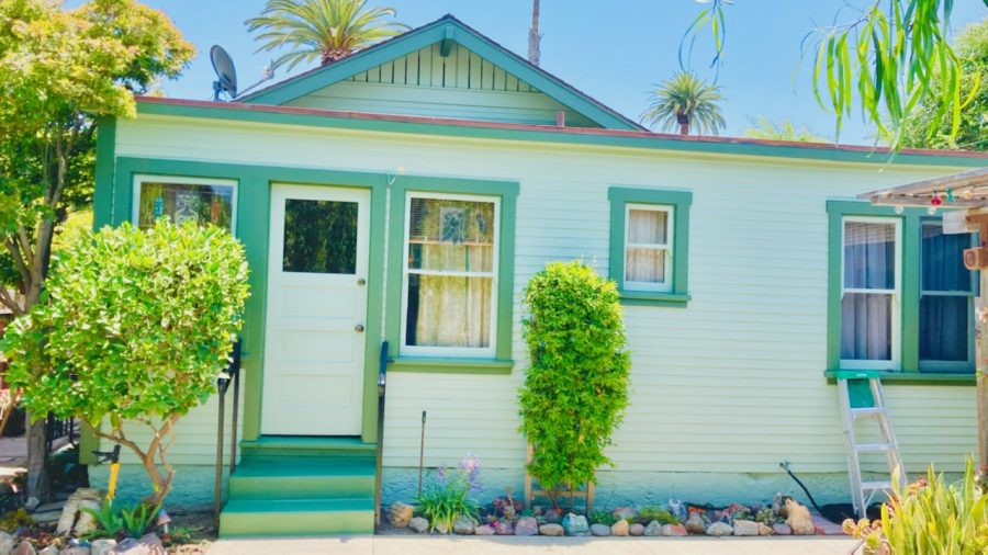 front of light green house with green trim. Preview Image 5