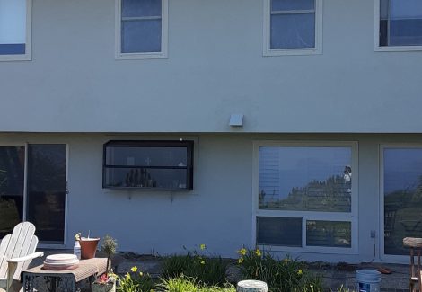 side view of stucco house after painting